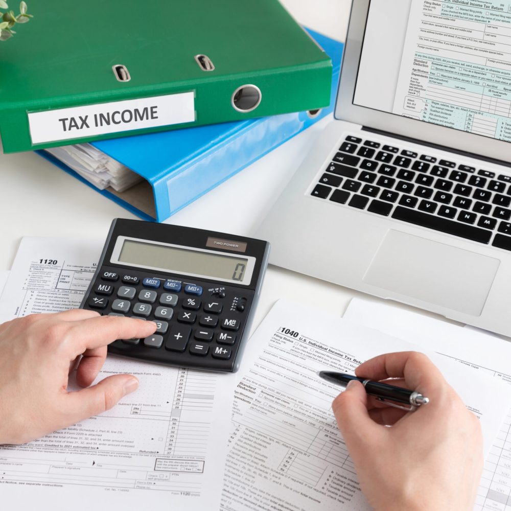 Man,Filling,Us,Tax,Form.,Us,Individual,Income,Tax,Return.