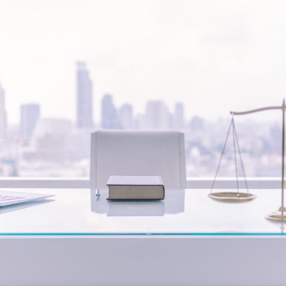 Law,Books,computer,And,Scales,Of,Justice,On,Desk,In,Lawyer